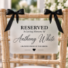 ChatGPT Image Sep 23, 2026, 02_32_31 PM Frosted acrylic reserved memorial chair sign with white ribbon for wedding ceremony