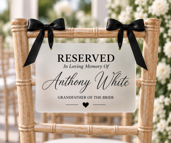 ChatGPT Image Sep 23, 2026, 02_32_31 PM Frosted acrylic reserved memorial chair sign with white ribbon for wedding ceremony