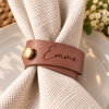 Emma Leather Napkin Ring Elegance Brown faux leather napkin ring engraved with Emma and finished with a gold button on a white napkin
