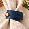 Matthew Navy Leather Napkin Ring Indigo faux leather napkin ring engraved with Matthew and finished with a gold button on a white wedding napkin